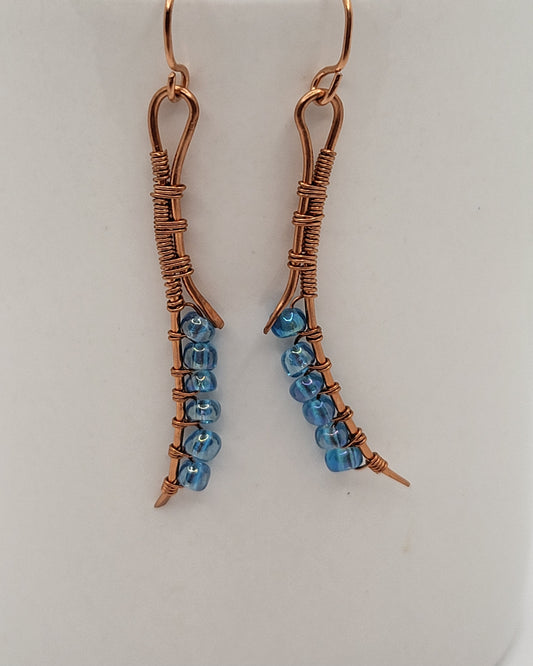 Long wire wrapped copper earrings with blue beads