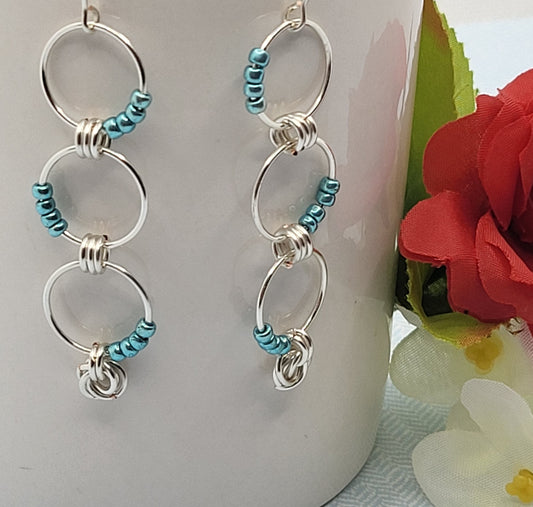 Three hoop earrings with blue beads